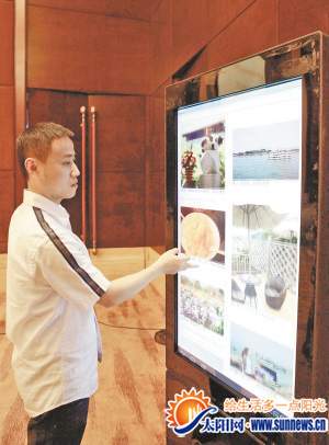 工作人員演示“智慧旅游”客戶端