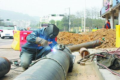 工人正在焊接新的鋼管，為燃?xì)夤艿肋w改施工做準(zhǔn)備