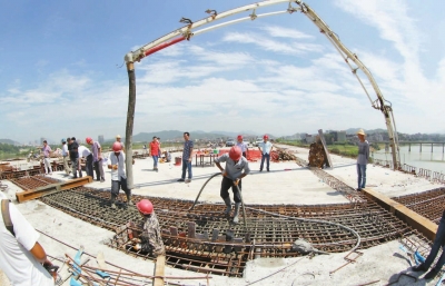 昨日，工人正在晉安大橋合龍段上抓緊澆灌混凝土。本